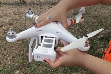 Researcher holding a drone during training
