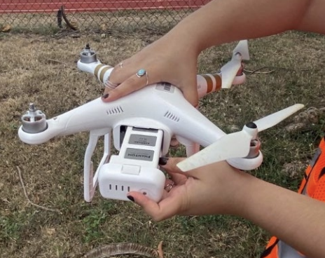 Researcher holding a drone during training